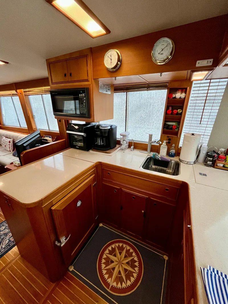 Slide: The Image of Interior of 1997 Grand Banks 49 Classic yacht kitchen with wood cabinetry and modern appliances. - 15