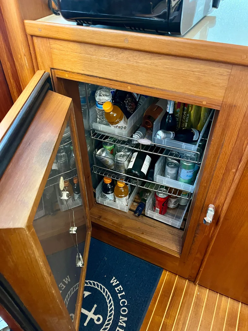 Slide: The Image of Mini fridge stocked with beverages inside a 1997 Grand Banks 49 Classic yacht. - 18