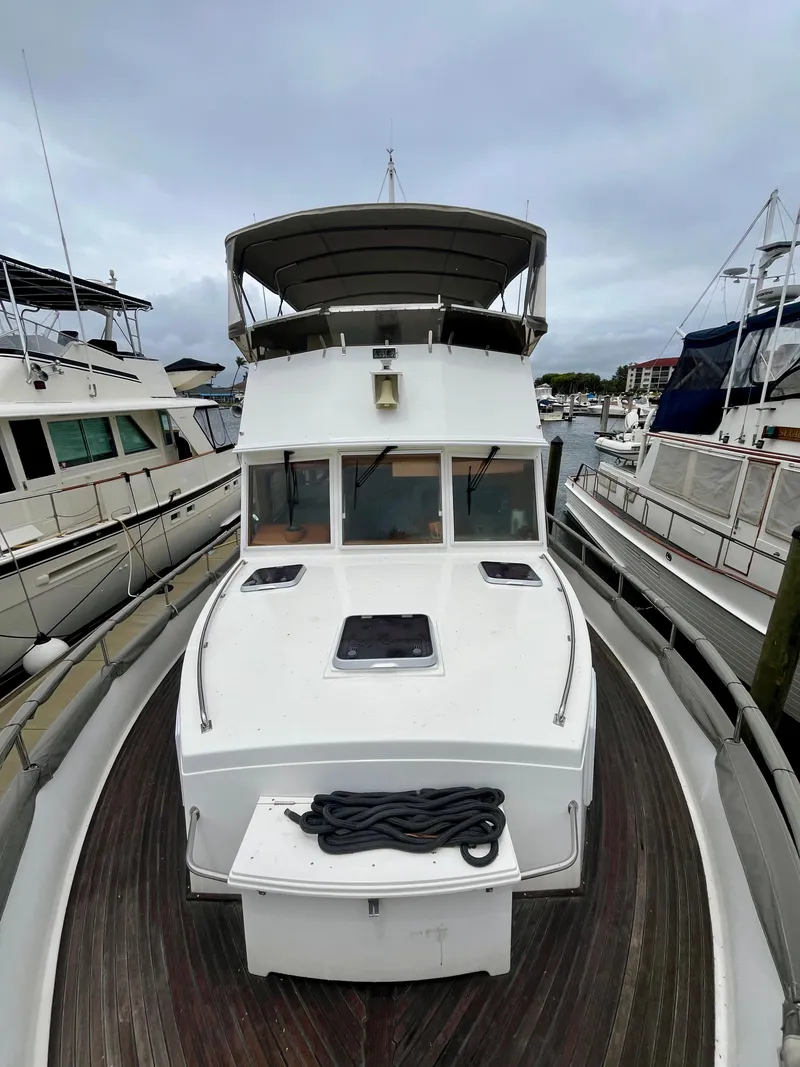Slide: The Image of 1997 Grand Banks 49 Classic yacht docked at marina, front view. - 2