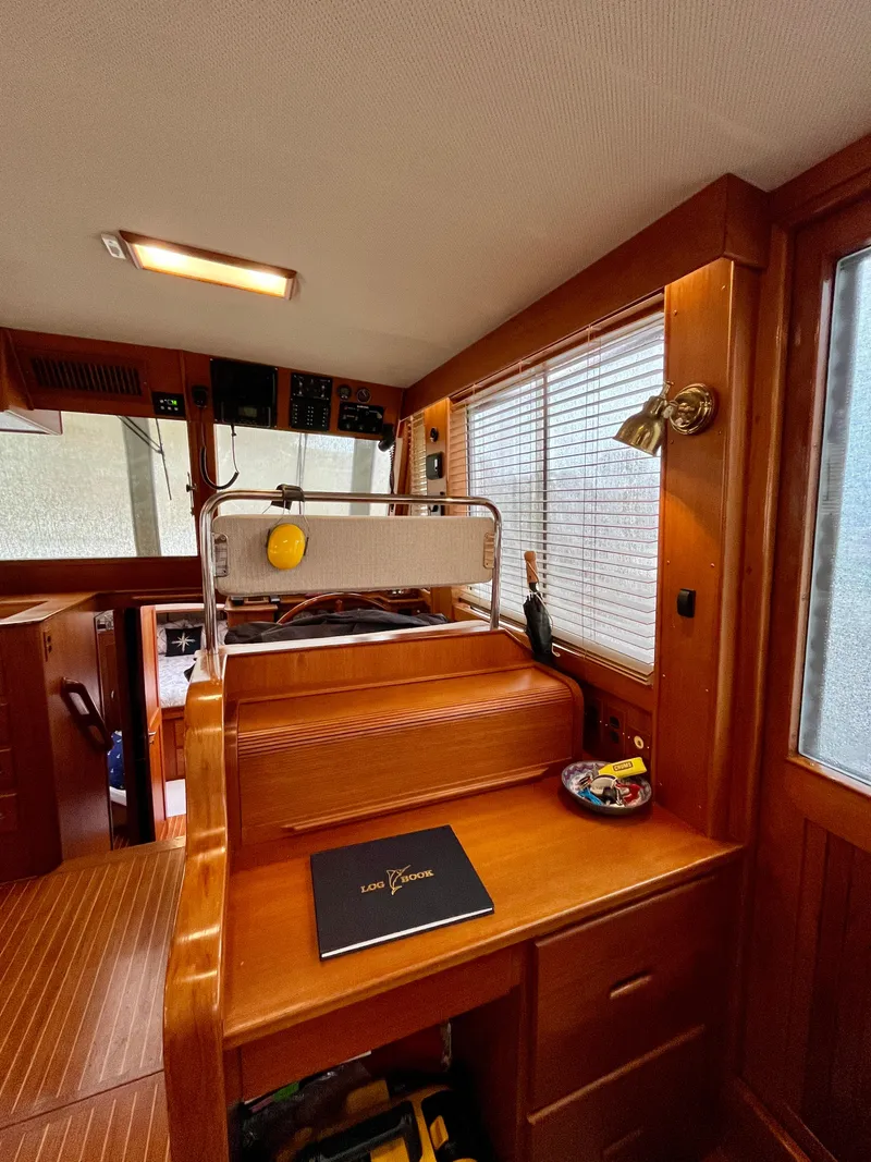 Slide: The Image of 1997 Grand Banks 49 Classic interior with wooden finish and navigation station. - 25