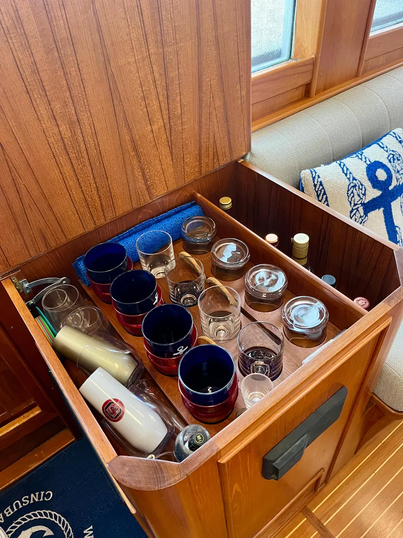 Slide: The Image of Storage compartment with glasses and bottles on a 1997 Grand Banks 49 Classic yacht. - 26