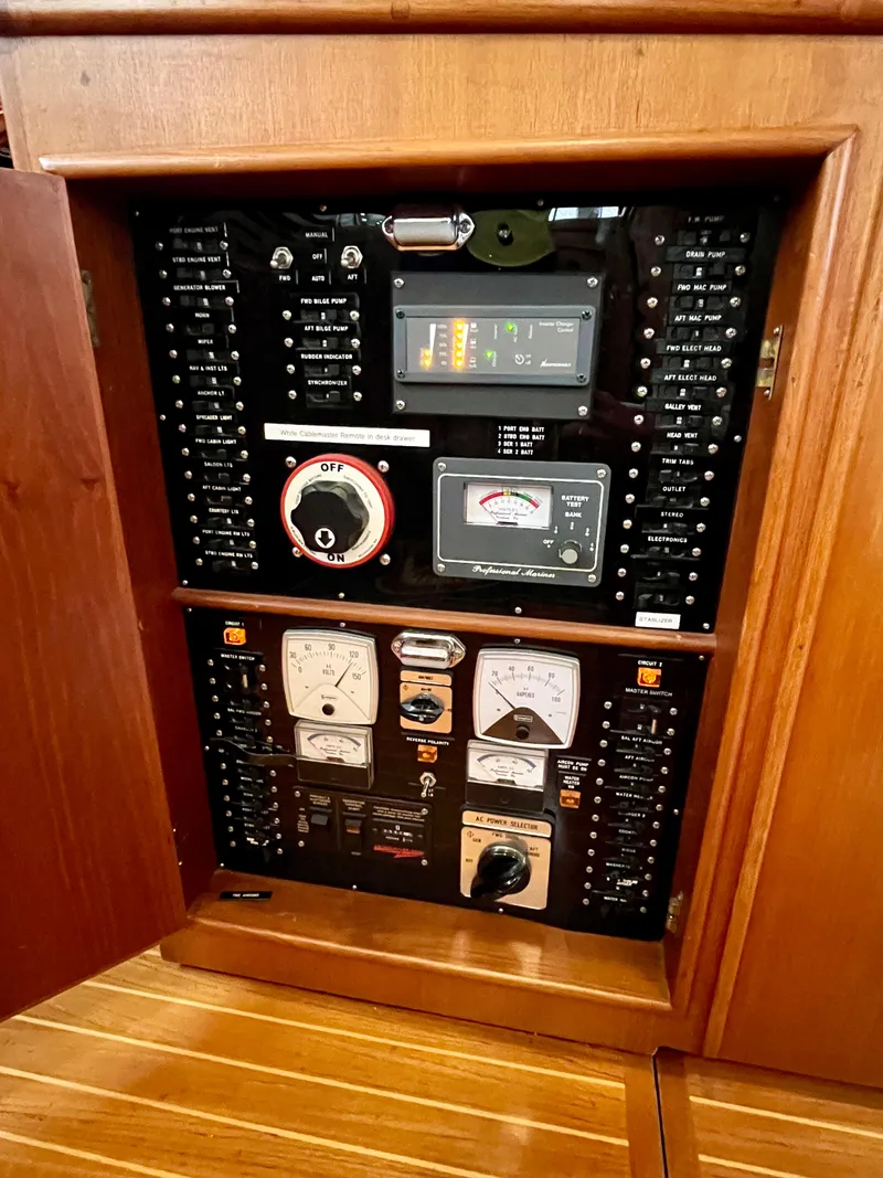 Slide: The Image of Electrical panel of a 1997 Grand Banks 49 Classic yacht, featuring various gauges and controls. - 27