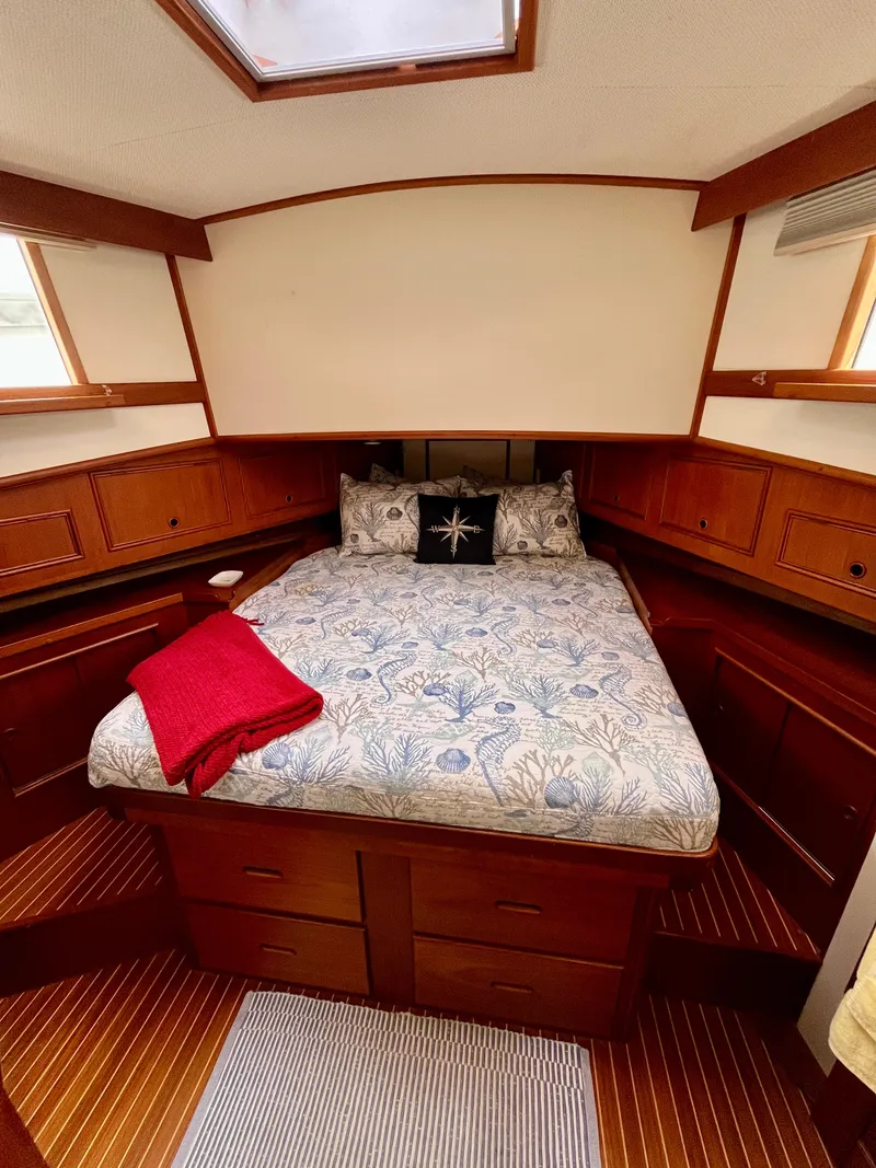 Slide: The Image of Cozy bedroom in 1997 Grand Banks 49 Classic yacht with wooden cabinetry and skylight. - 31