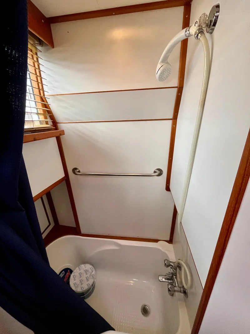 Slide: The Image of Shower area in 1997 Grand Banks 49 Classic yacht with wooden accents and handheld showerhead. - 33