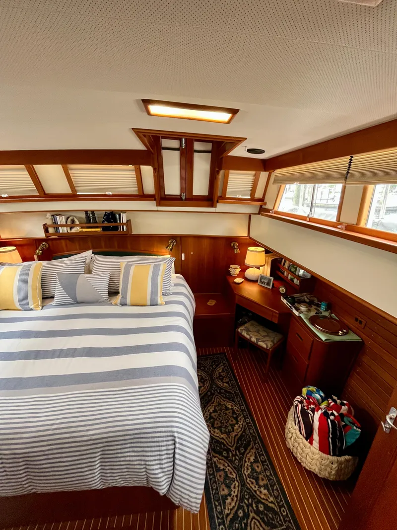 Slide: The Image of Interior of 1997 Grand Banks 49 Classic yacht with cozy bedroom and striped bedding. - 35