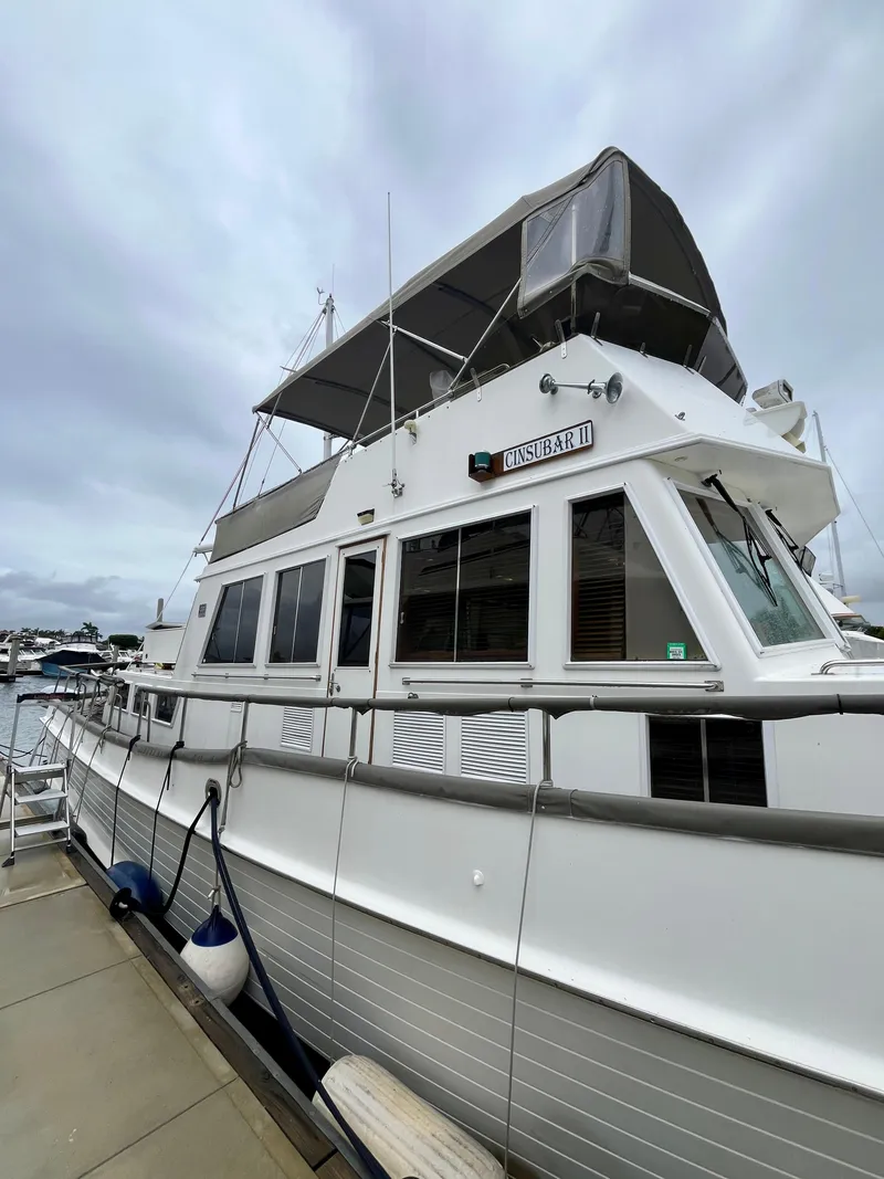Slide: The Image of 1997 Grand Banks 49 Classic yacht docked at marina under cloudy sky. - 4