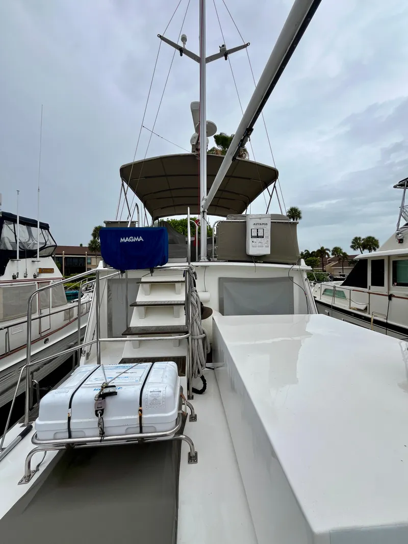 Slide: The Image of 1997 Grand Banks 49 Classic yacht deck with equipment and canopy, docked at marina. - 41