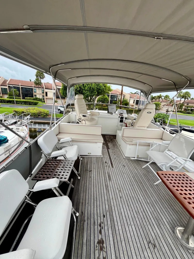 Slide: The Image of 1997 Grand Banks 49 Classic yacht deck with seating and canopy, docked in a marina. - 43
