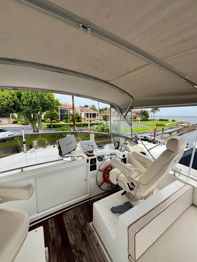 Slide: The Image of 1997 Grand Banks 49 Classic yacht helm with waterfront view and luxurious seating. - 46