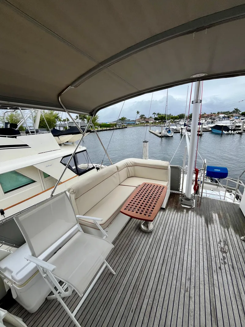 Slide: The Image of 1997 Grand Banks 49 Classic yacht deck with seating, docked at marina. - 47