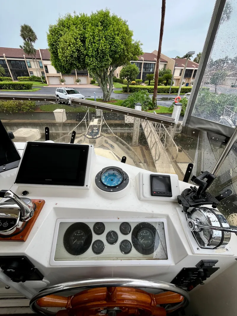 Slide: The Image of Helm of 1997 Grand Banks 49 Classic yacht with navigation instruments and view of marina. - 48