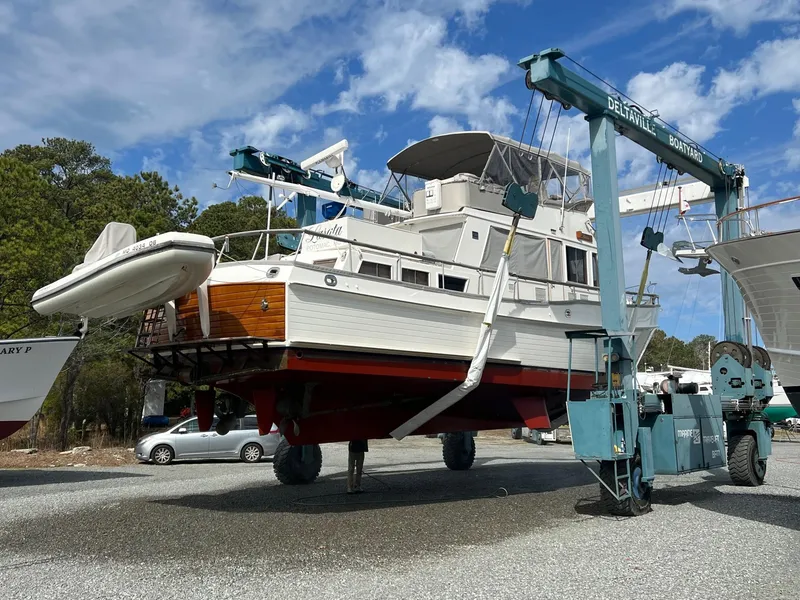 Slide: The Image of Grand Banks 49 Classic yacht from 1997 being lifted by a boat hoist. - 7