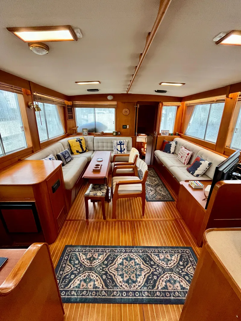 Slide: The Image of Interior of a 1997 Grand Banks 49 Classic yacht with elegant wood finish and cozy seating. - 8