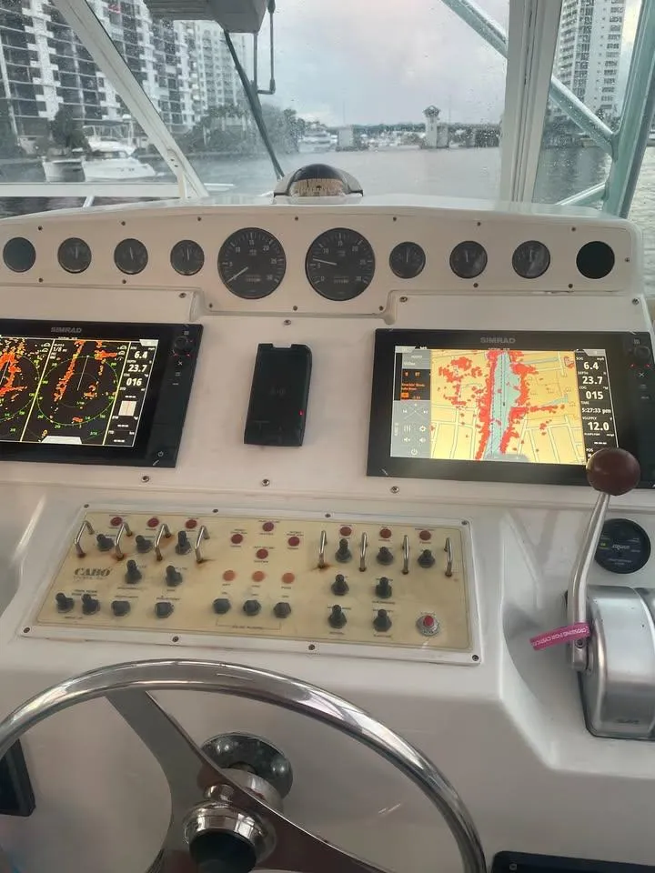 Slide: The Image of Control panel of a 2001 Cabo 35 Express boat with navigation screens and gauges. - 10
