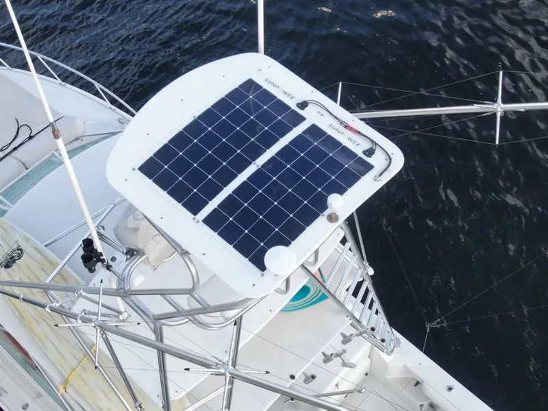 Slide: The Image of Solar panel on 2001 Cabo 35 Express boat, mounted on metal frame, over water. - 11