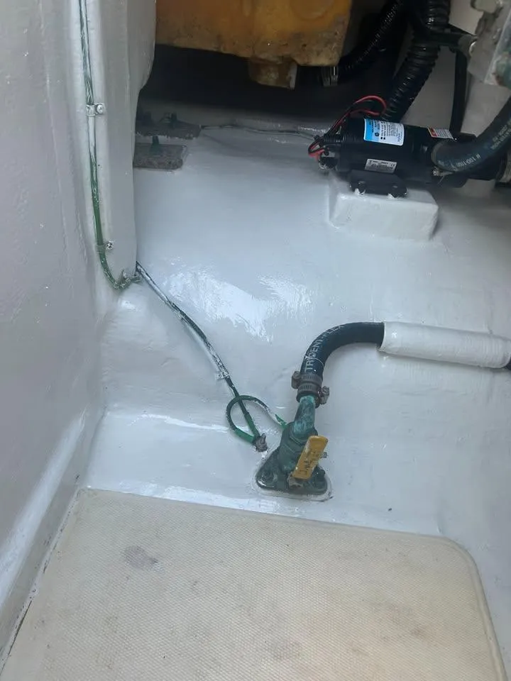 Slide: The Image of 2001 Cabo 35 Express boat interior with visible wiring and plumbing components. - 12