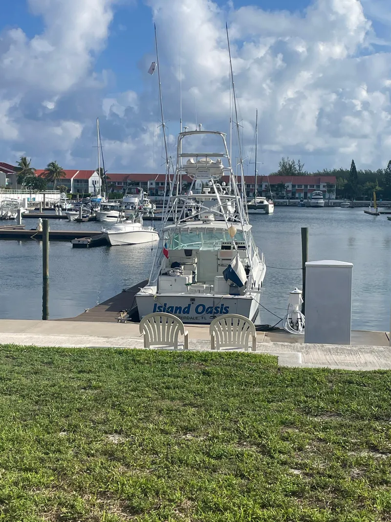 Slide: The Image of 2001 Cabo 35 Express boat docked at marina under cloudy sky. - 4