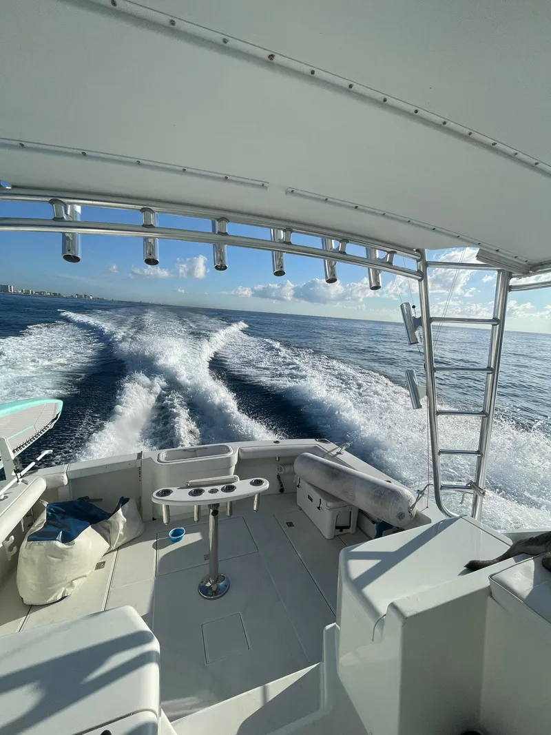 Slide: The Image of 2001 Cabo 35 Express boat cruising on open water, leaving a wake behind. - 5