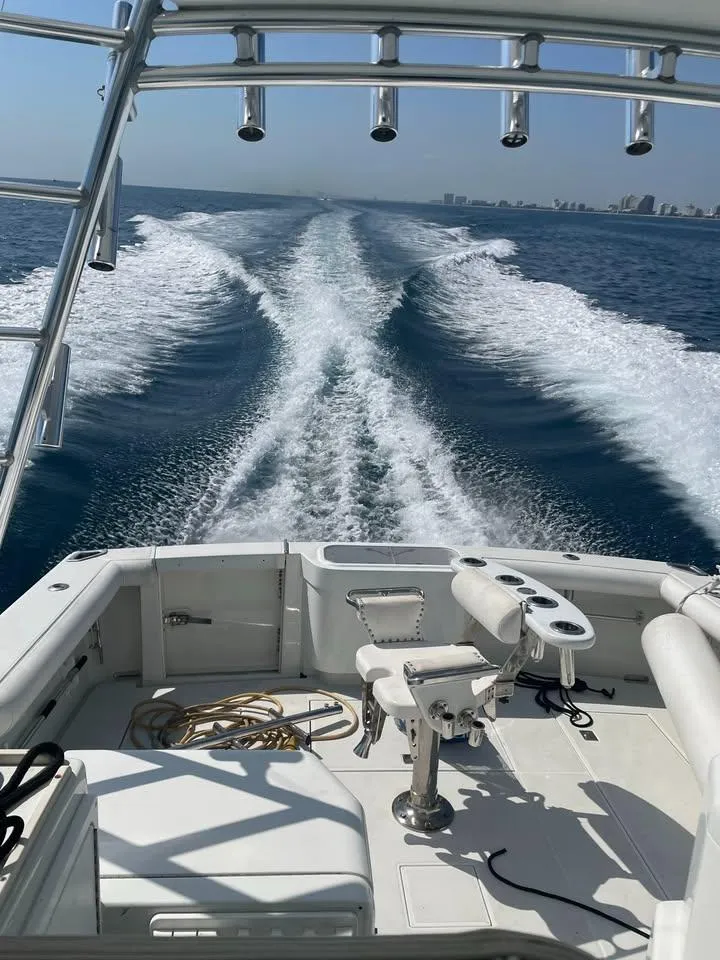Slide: The Image of 2001 Cabo 35 Express boat cruising on open water, leaving a wake behind. - 6