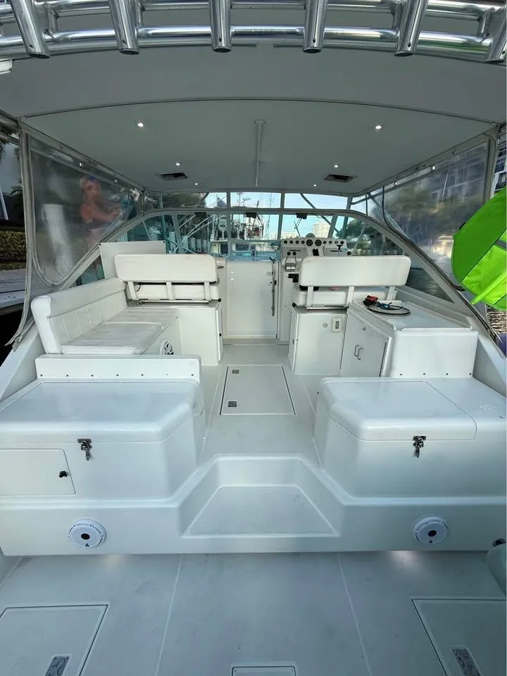 Slide: The Image of 2001 Cabo 35 Express boat interior with seating and helm station. - 8