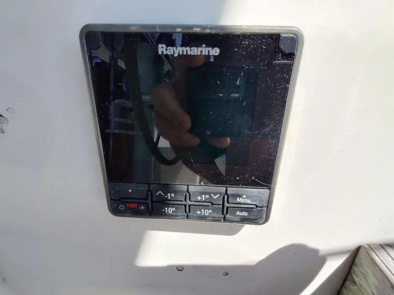 Slide: The Image of Raymarine control panel on 1987 Catalina C-34 sailboat, featuring navigation buttons. - 18