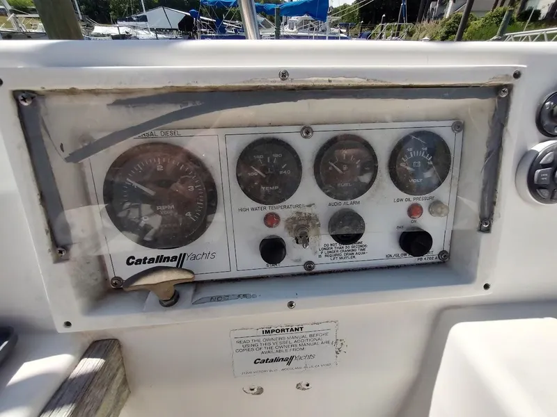 Slide: The Image of Control panel of a 1987 Catalina C-34 sailboat with gauges and switches. - 19