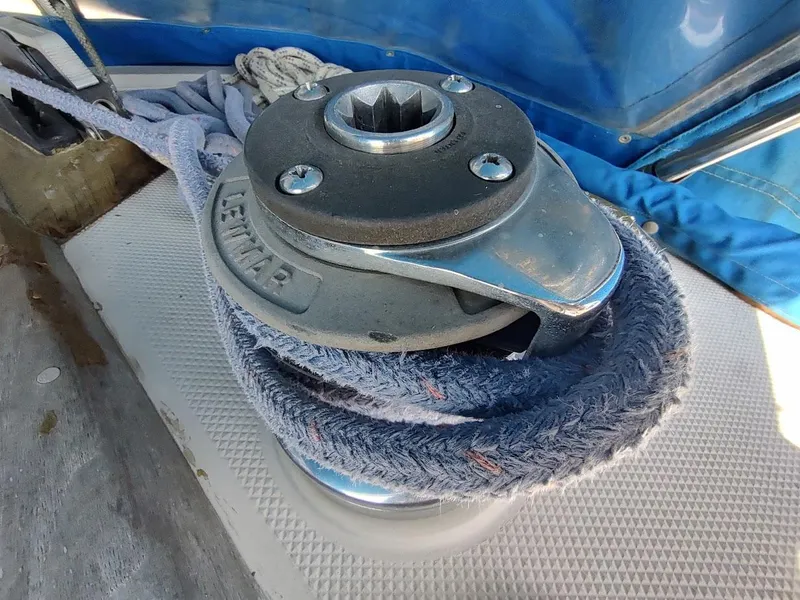 Slide: The Image of Winch on 1987 Catalina C-34 sailboat with blue rope and Lewmar branding. - 27