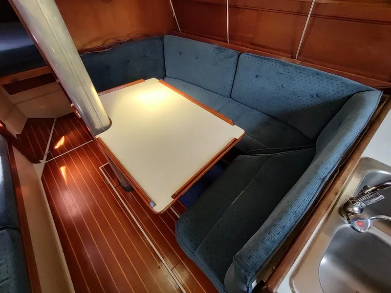 Slide: The Image of Interior of 1987 Catalina C-34 sailboat with cozy seating and wooden flooring. - 32