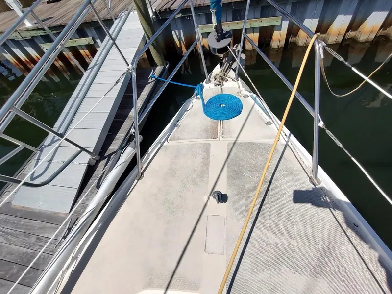 Slide: The Image of 1987 Catalina C-34 sailboat deck with blue rope, docked at marina. - 6