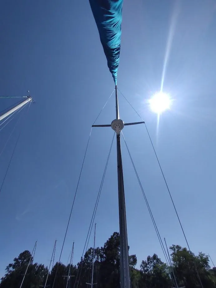 Slide: The Image of Sailboat mast of 1987 Catalina C-34 under clear blue sky with sun shining. - 9