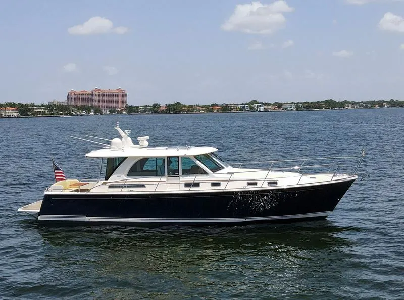 The Image of 2026 Sabre 45 Salon Express yacht cruising on a sunlit waterway. - 0