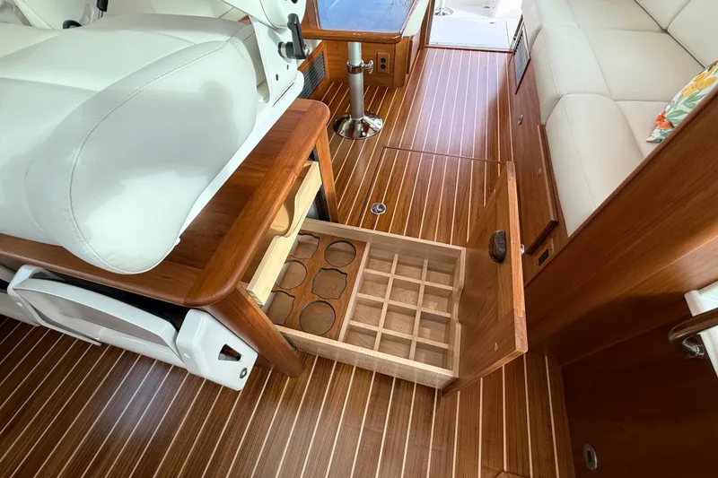 Slide: The Image of 2026 Sabre 45 Salon Express interior with open wooden storage drawer and elegant seating. - 15