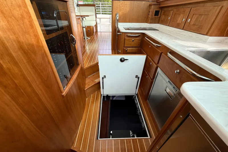 Slide: The Image of Interior of 2026 Sabre 45 Salon Express yacht with open hatch and wooden cabinetry. - 20