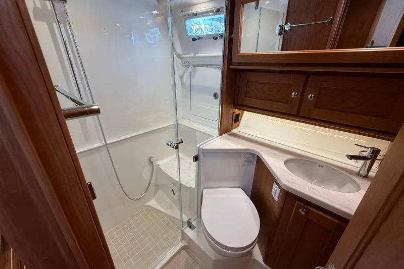 Slide: The Image of Luxurious bathroom in 2026 Sabre 45 Salon Express yacht with modern fixtures and wood cabinetry. - 24