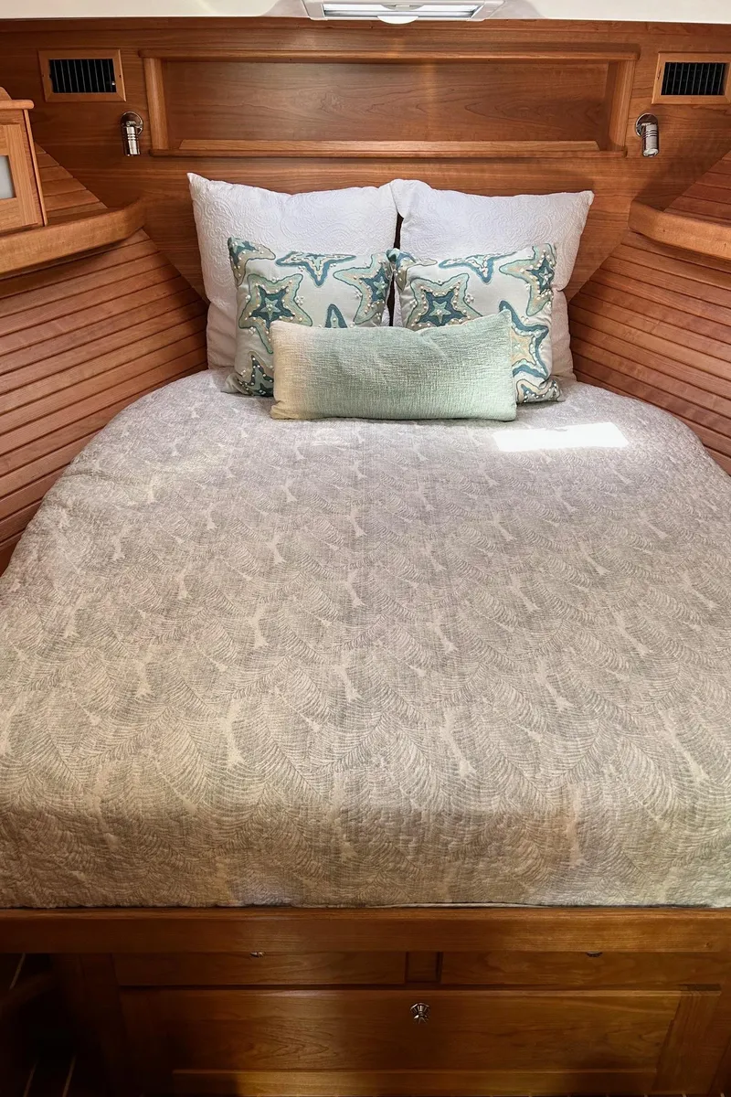 Slide: The Image of 2026 Sabre 45 Salon Express yacht exterior with open door and sleek design. - 7