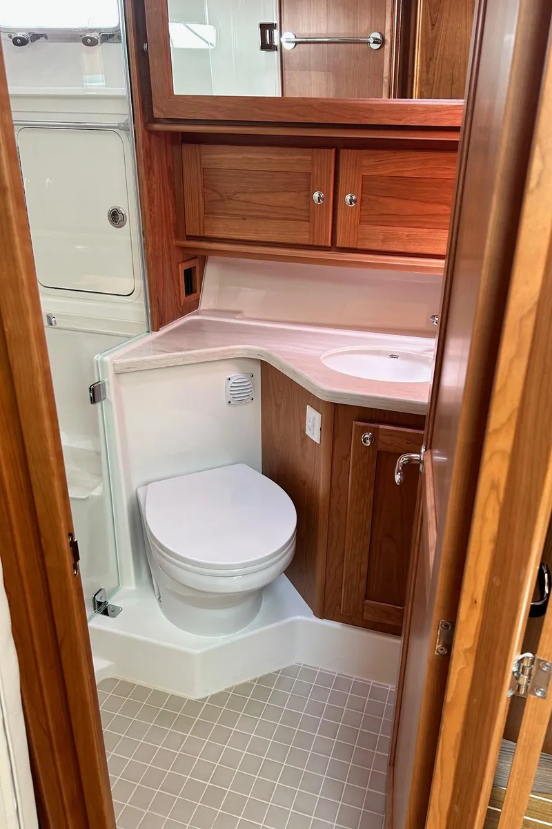 Slide: The Image of 2026 Sabre 45 Salon Express yacht with open cabin door, showcasing interior. - 8