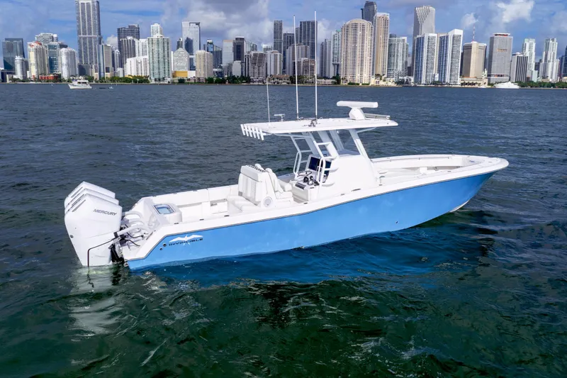 The Image of 2025 Invincible 36 Open boat on water with city skyline in background. - 0