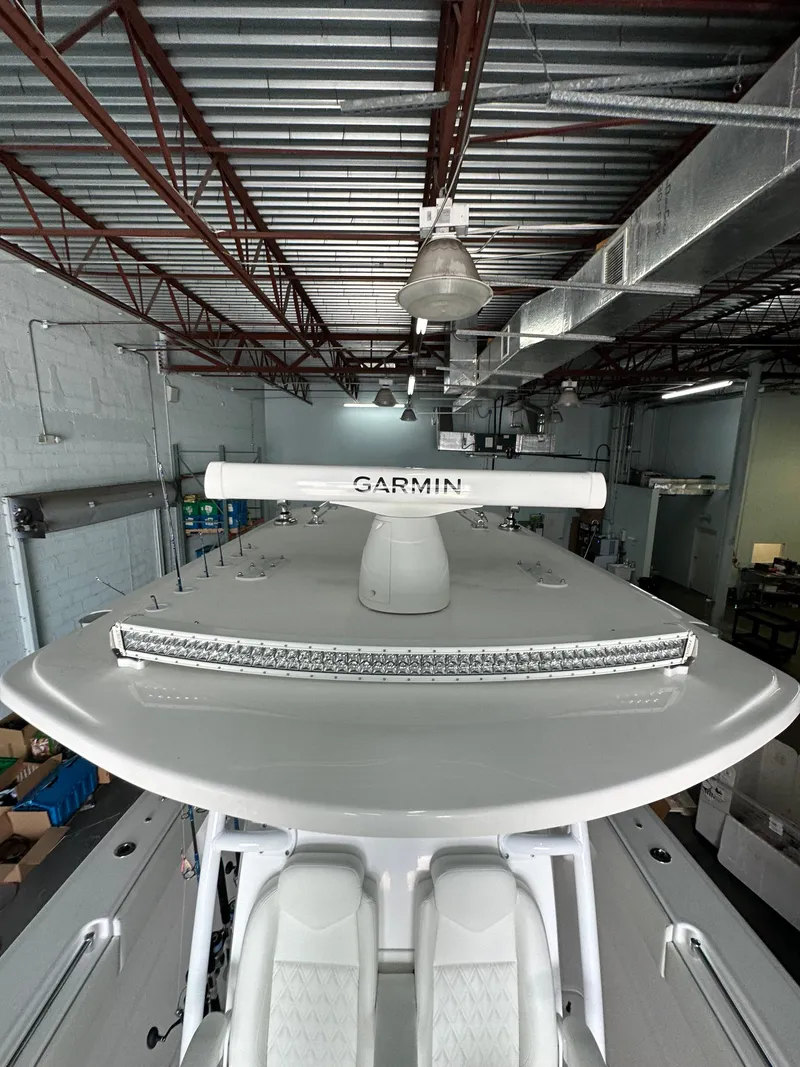Slide: The Image of 2025 Invincible 36 Open boat with Garmin radar in a warehouse setting. - 7