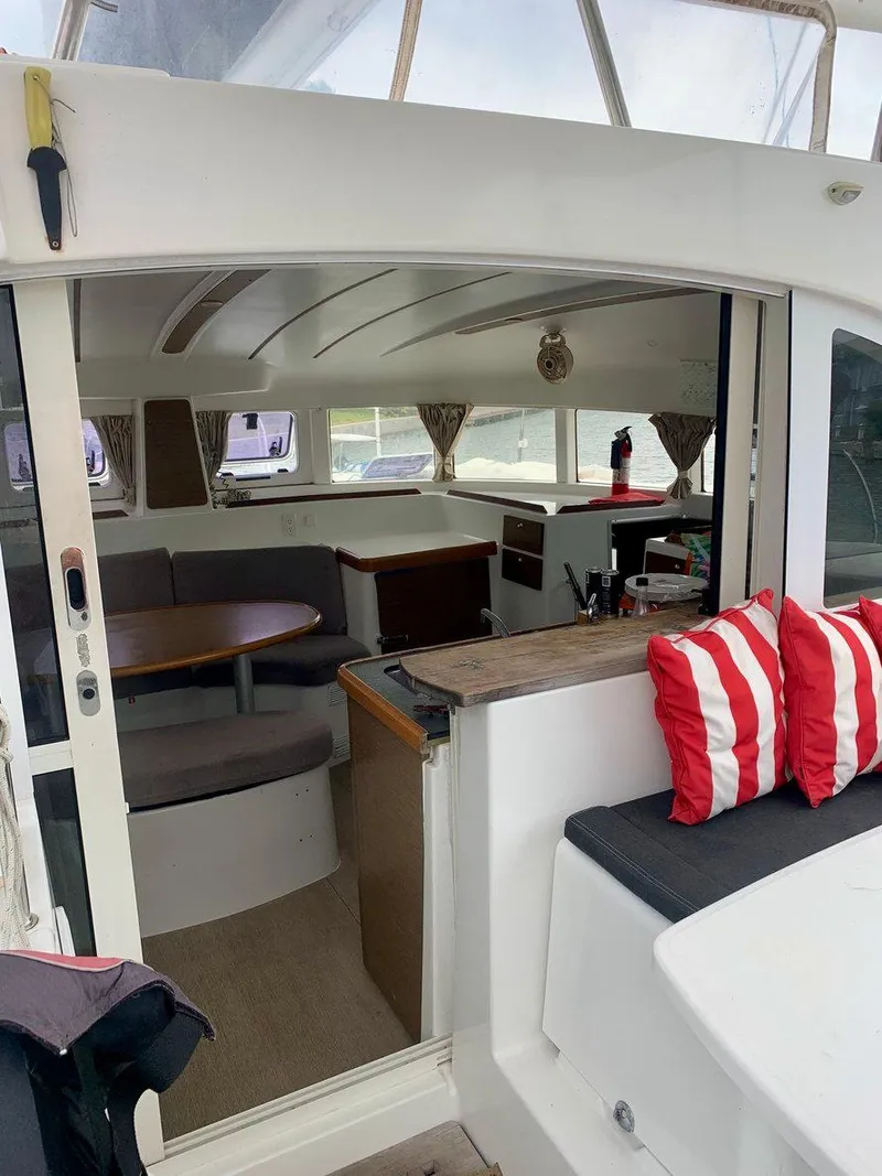 Slide: The Image of Interior view of 2019 Lagoon 380 S2 4/2 catamaran with seating and striped cushions. - 11