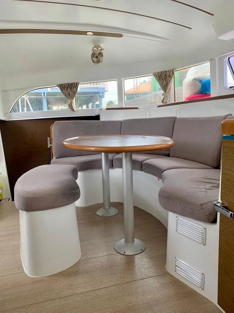 Slide: The Image of Interior of 2019 Lagoon 380 S2 4/2 catamaran with cozy seating and round table. - 16