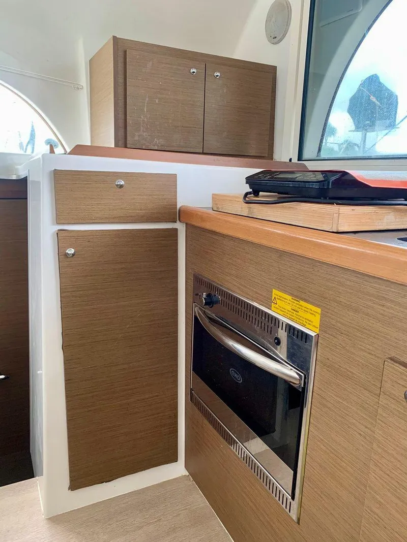 Slide: The Image of Interior of 2019 Lagoon 380 S2 4/2 yacht with modern kitchen cabinetry. - 20