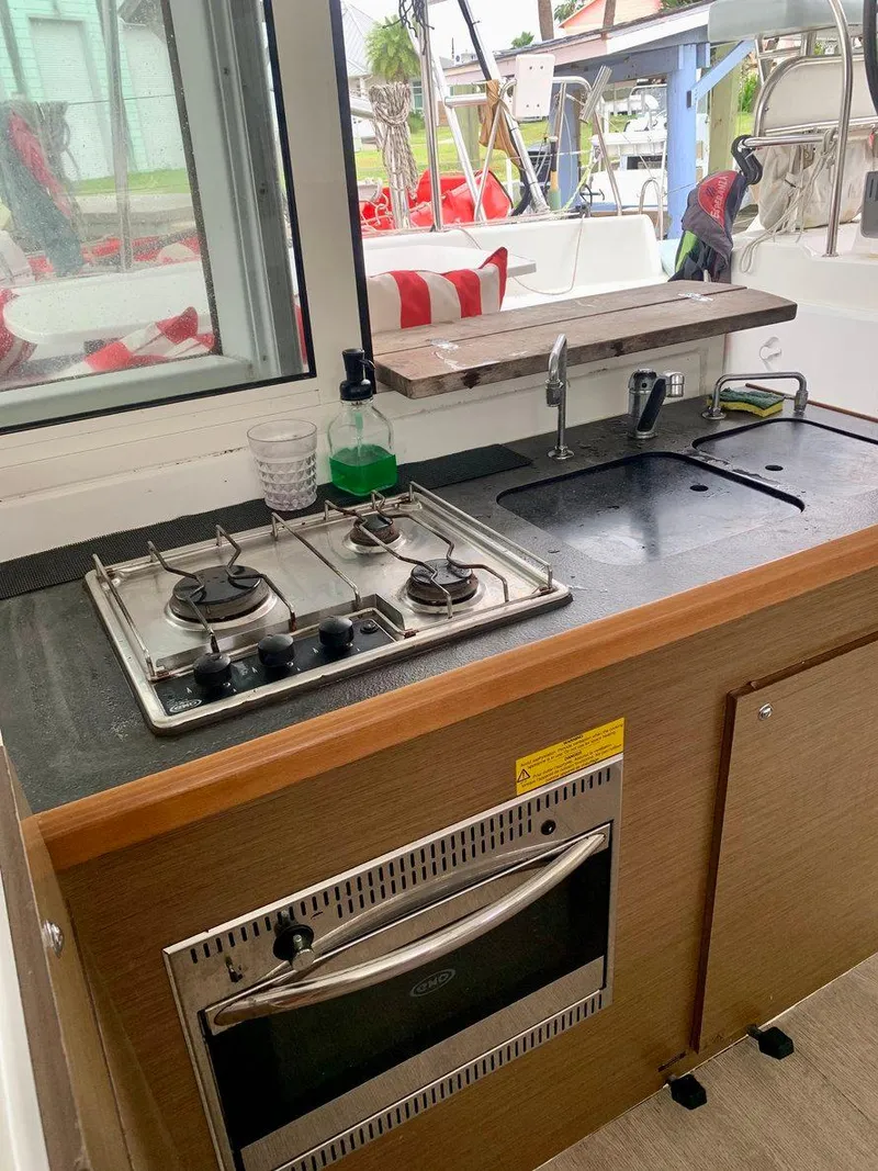 Slide: The Image of 2019 Lagoon 380 S2 4/2 yacht kitchen with stove and sink. - 22