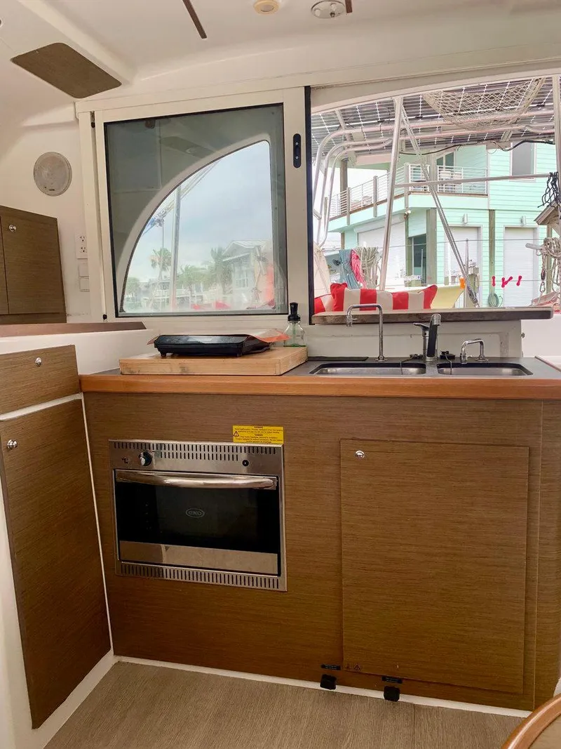 Slide: The Image of Interior of 2019 Lagoon 380 S2 4/2 yacht kitchen with oven and sink. - 23