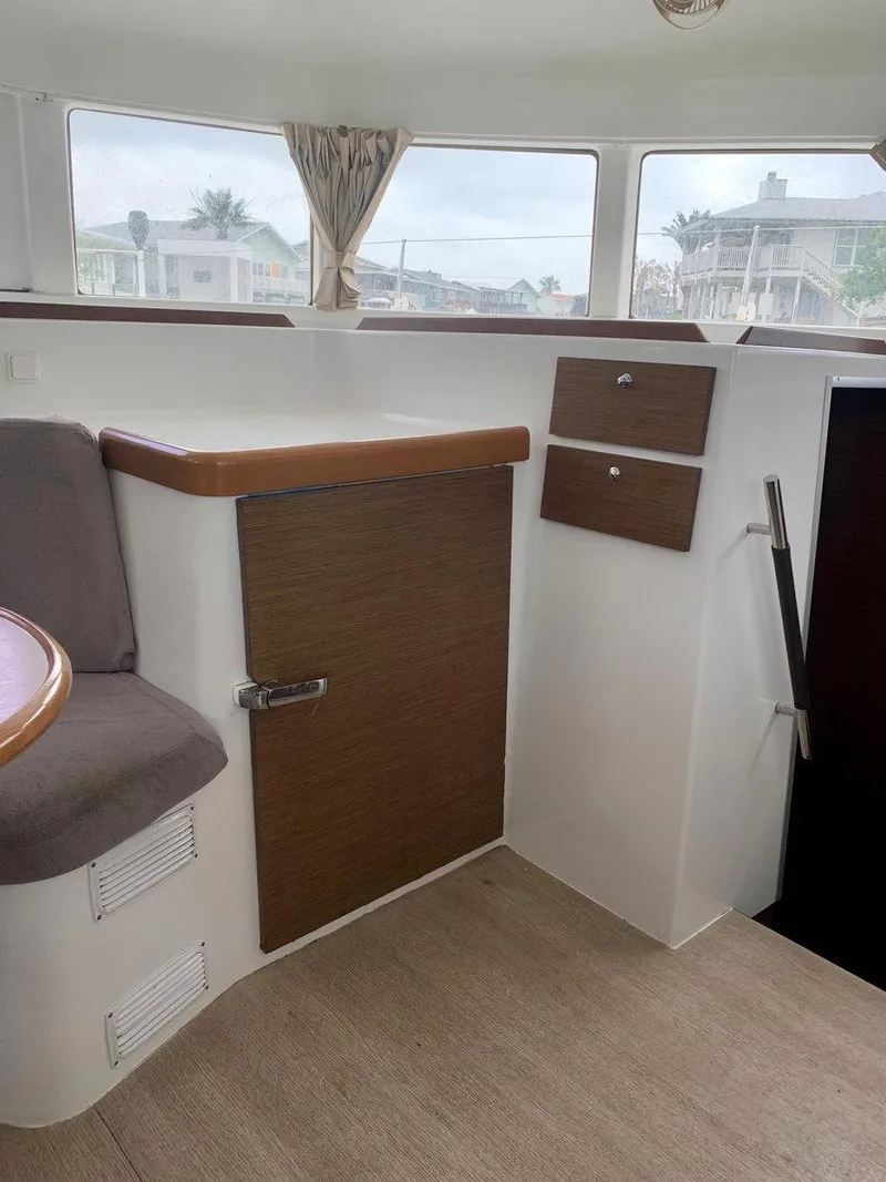 Slide: The Image of Interior of 2019 Lagoon 380 S2 4/2 catamaran with wood accents and seating. - 25