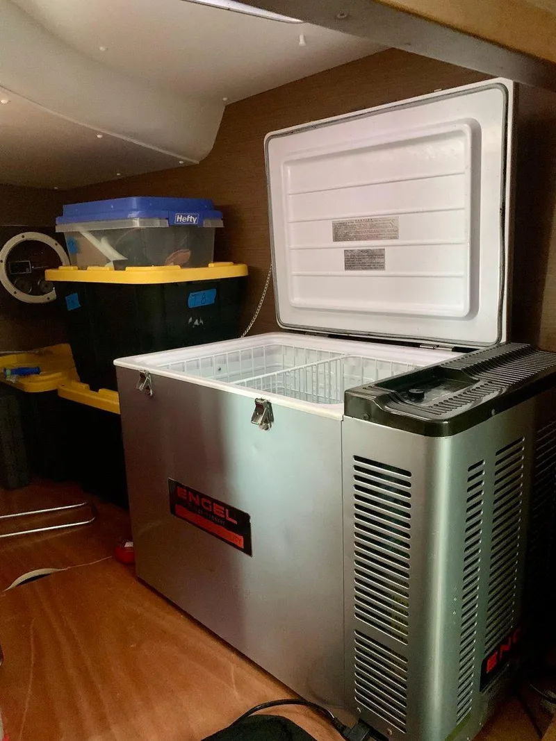 Slide: The Image of Open freezer in 2019 Lagoon 380 S2 4/2 yacht interior with storage bins nearby. - 27