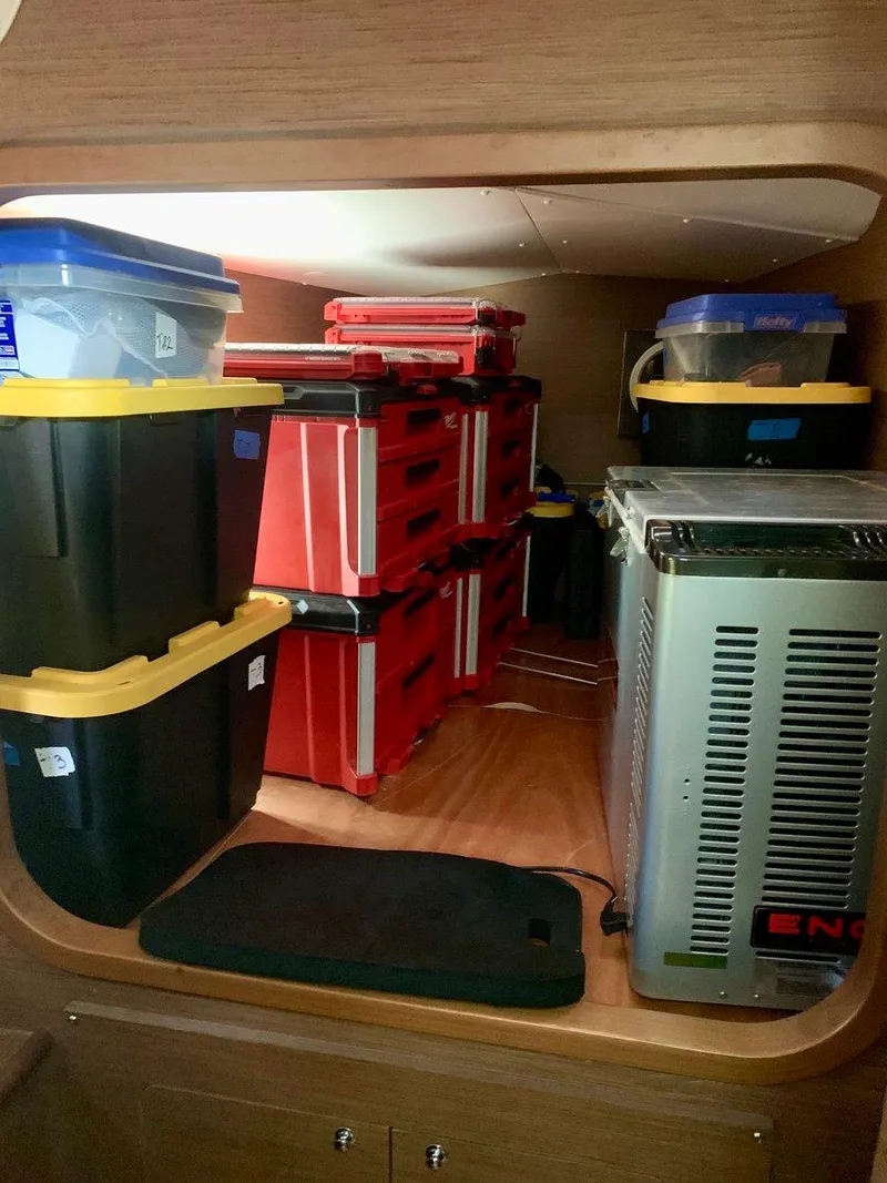 Slide: The Image of Storage area in a 2019 Lagoon 380 S2 4/2 with organized containers and equipment. - 28