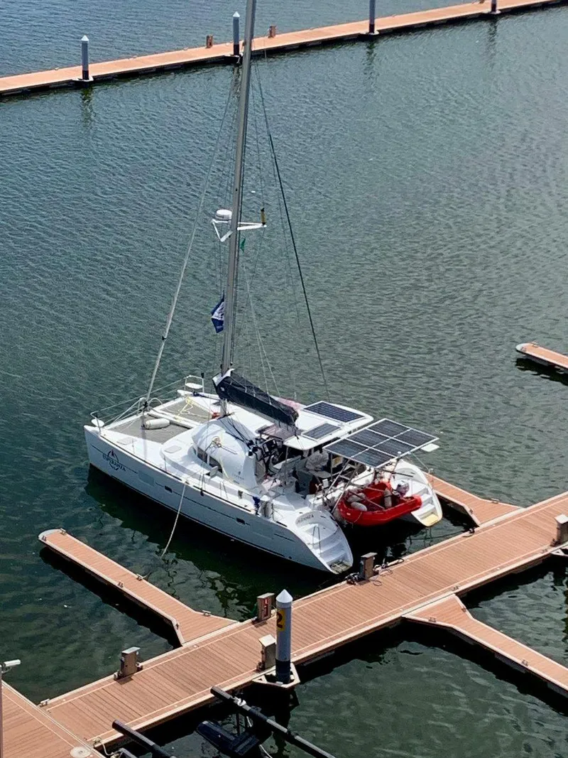 Slide: The Image of 2019 Lagoon 380 S2 4/2 catamaran docked at marina with solar panels. - 3