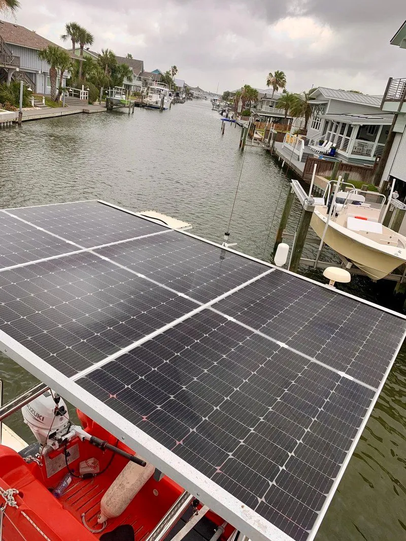 Slide: The Image of Solar panels on a 2019 Lagoon 380 S2 4/2 catamaran in a canal setting. - 4