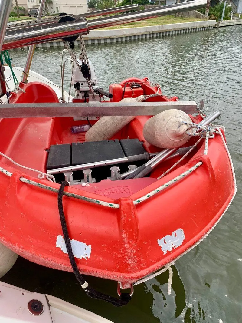 Slide: The Image of Red dinghy on Lagoon 380 S2 4/2, 2019 model, docked by waterfront. - 45