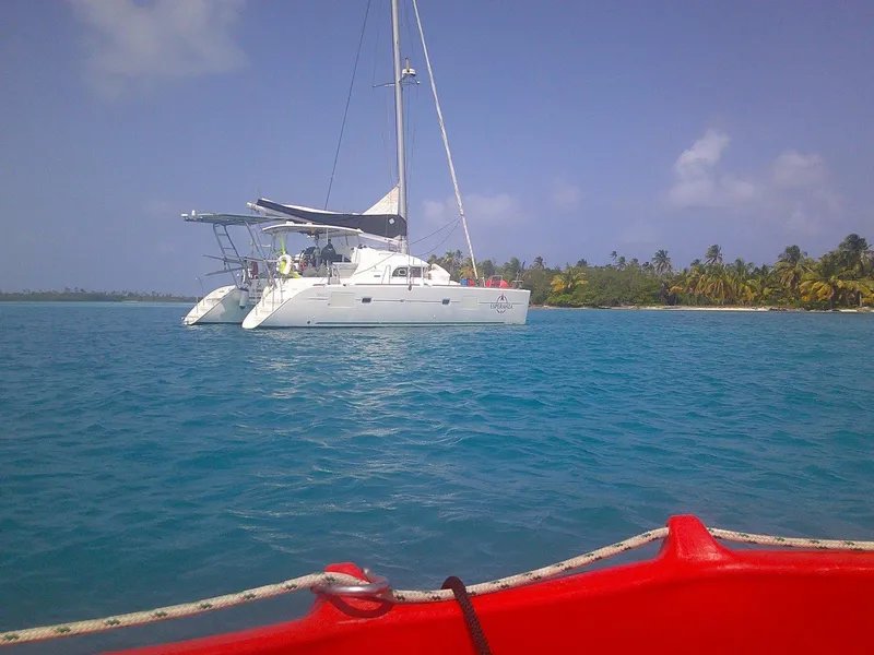 Slide: The Image of 2019 Lagoon 380 S2 catamaran anchored near tropical island with clear blue water. - 48